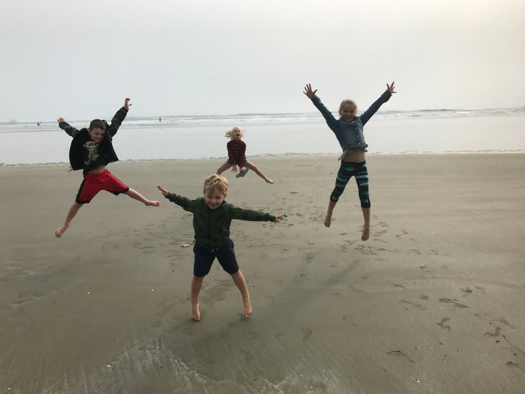 kids-jumping-on-beach-on-vancouver-island