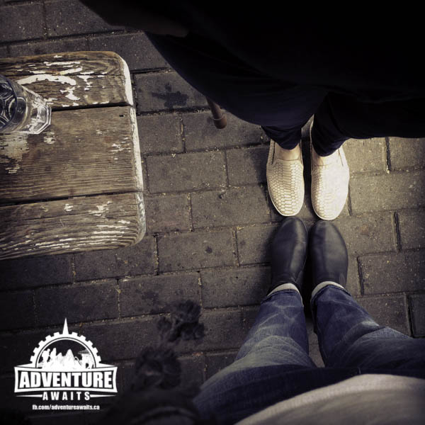 Photo looking down at 2 people's legs standing facing each other 
