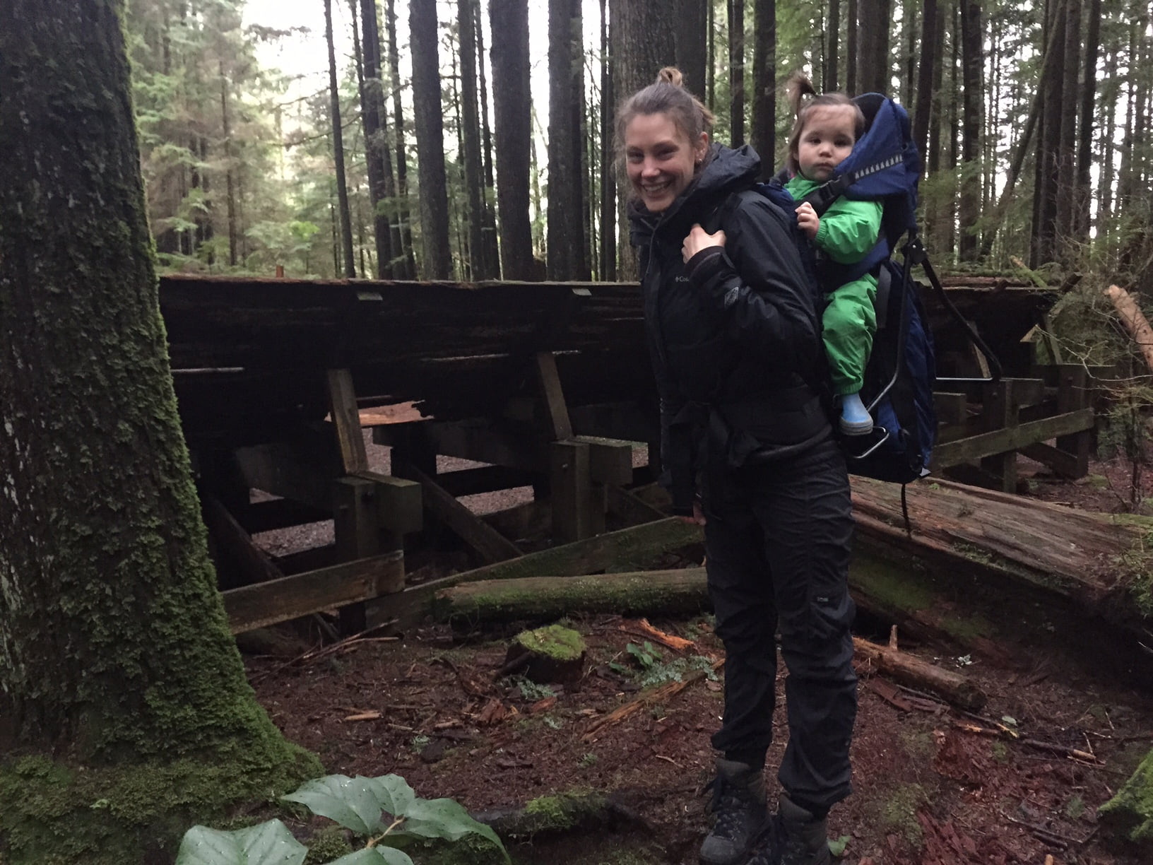 Woman hiking with a baby on her back who knows how to have a successful family hiking trip