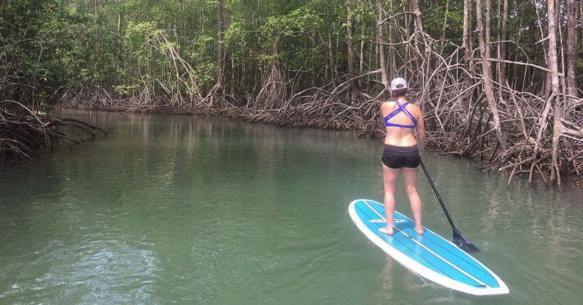 woman stand up paddle boarding at the run like a girl adventure retreat in costa rica