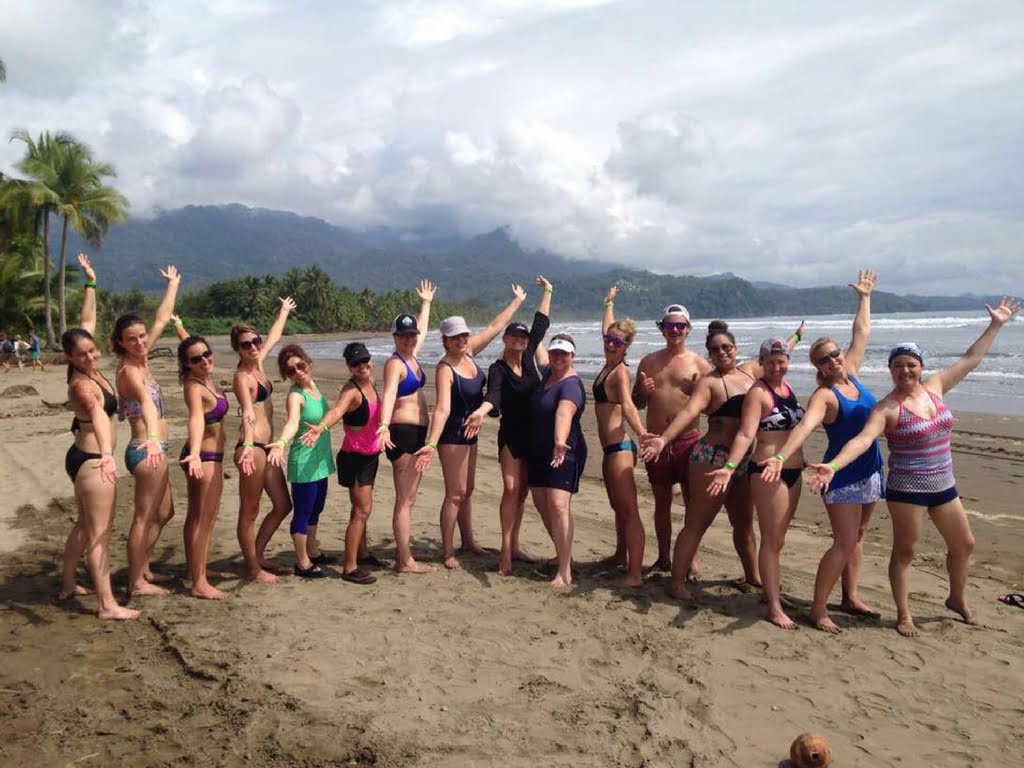 group photo of retreat women on beach in dominical, costa rica