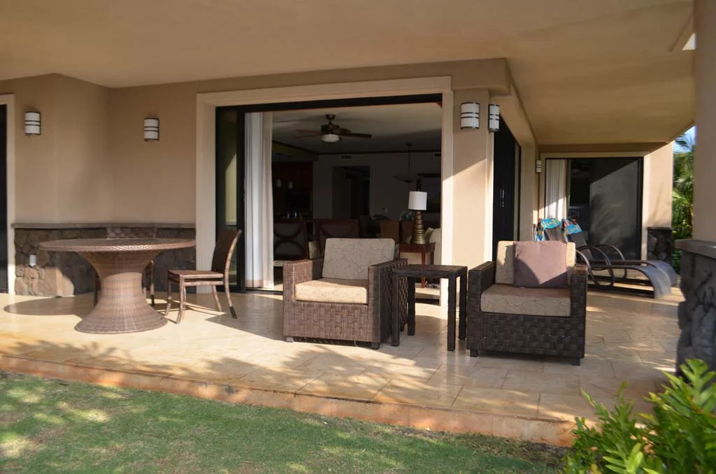 ground floor lanai complete with chairs and lounge chairs with large doors going into the room