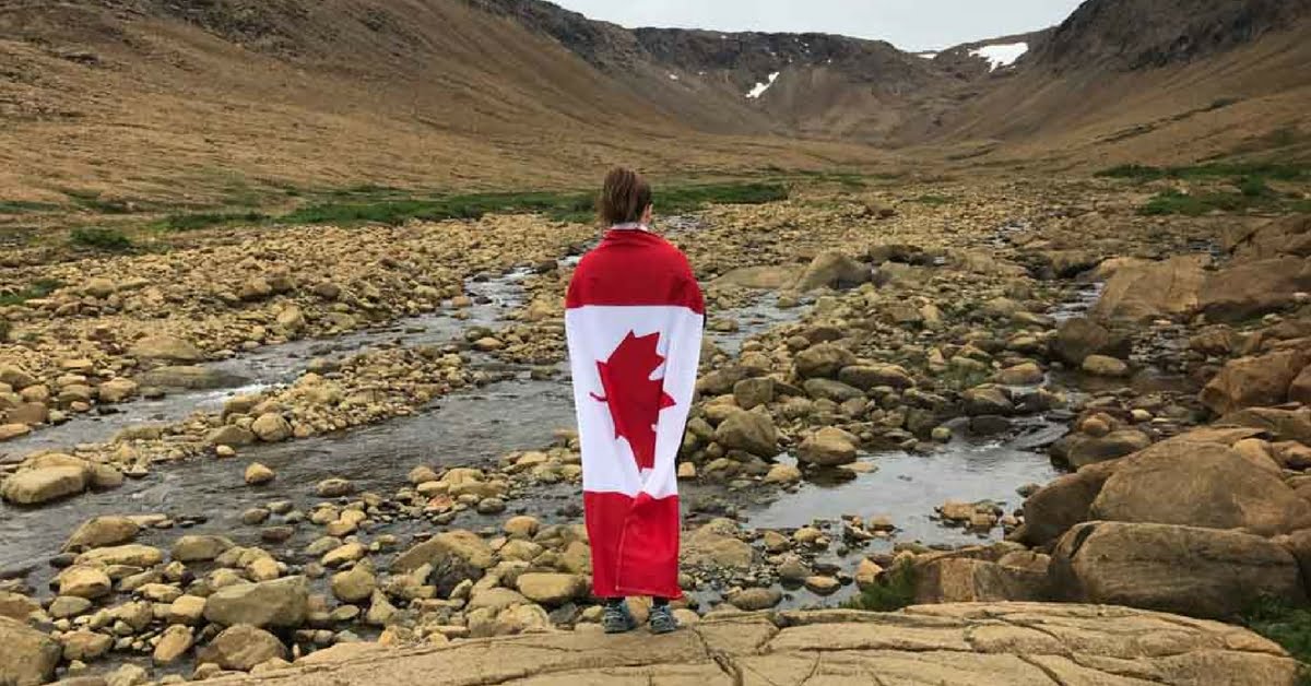 woman-standing-with-canada-flag-in-gros-morne