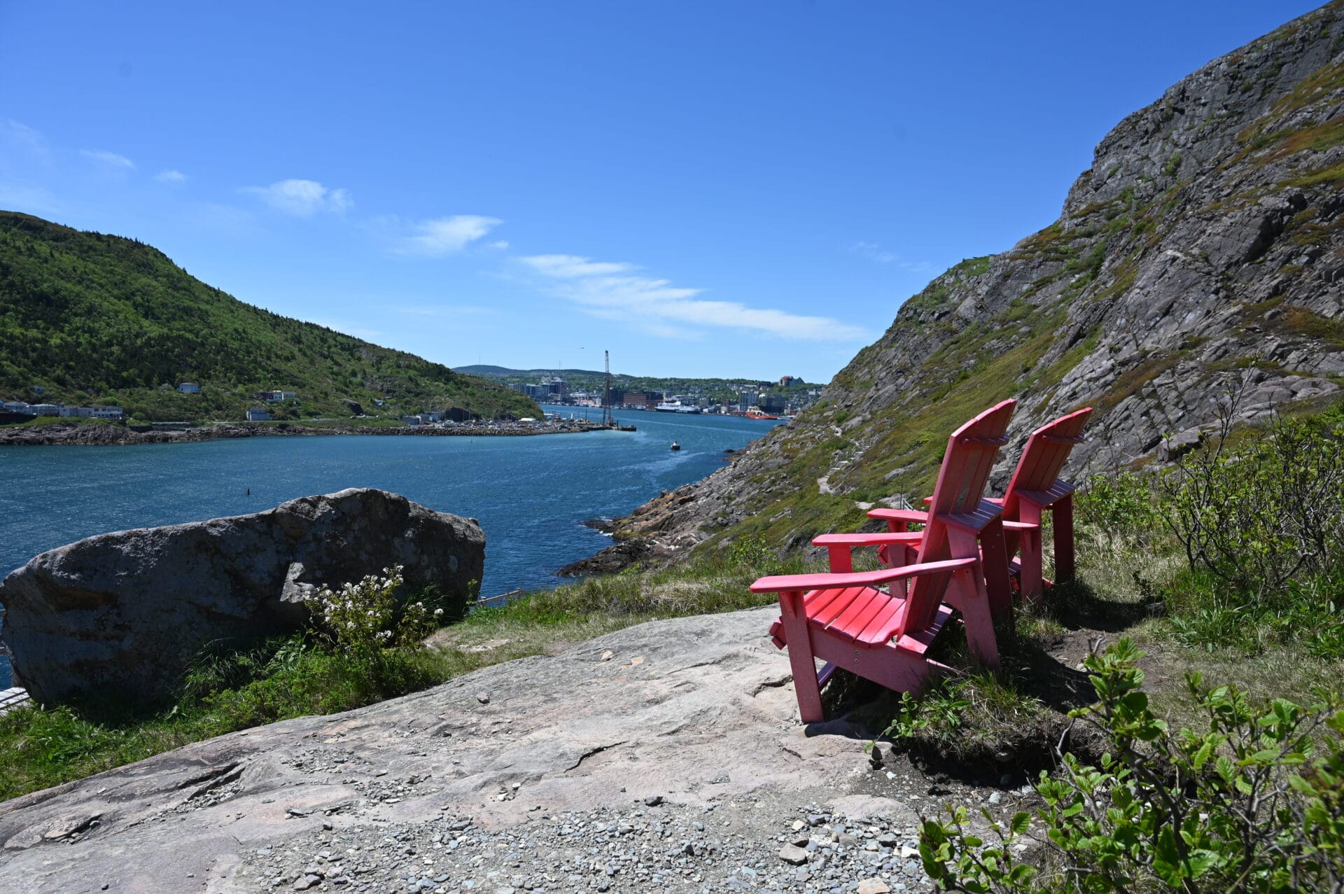 iconic red parks canada chairs sitting on the North Head Trail to Signal Hill