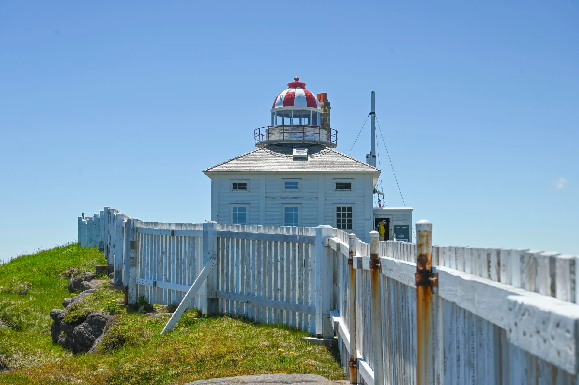 looking along the white fence at the cape spear lighthouse