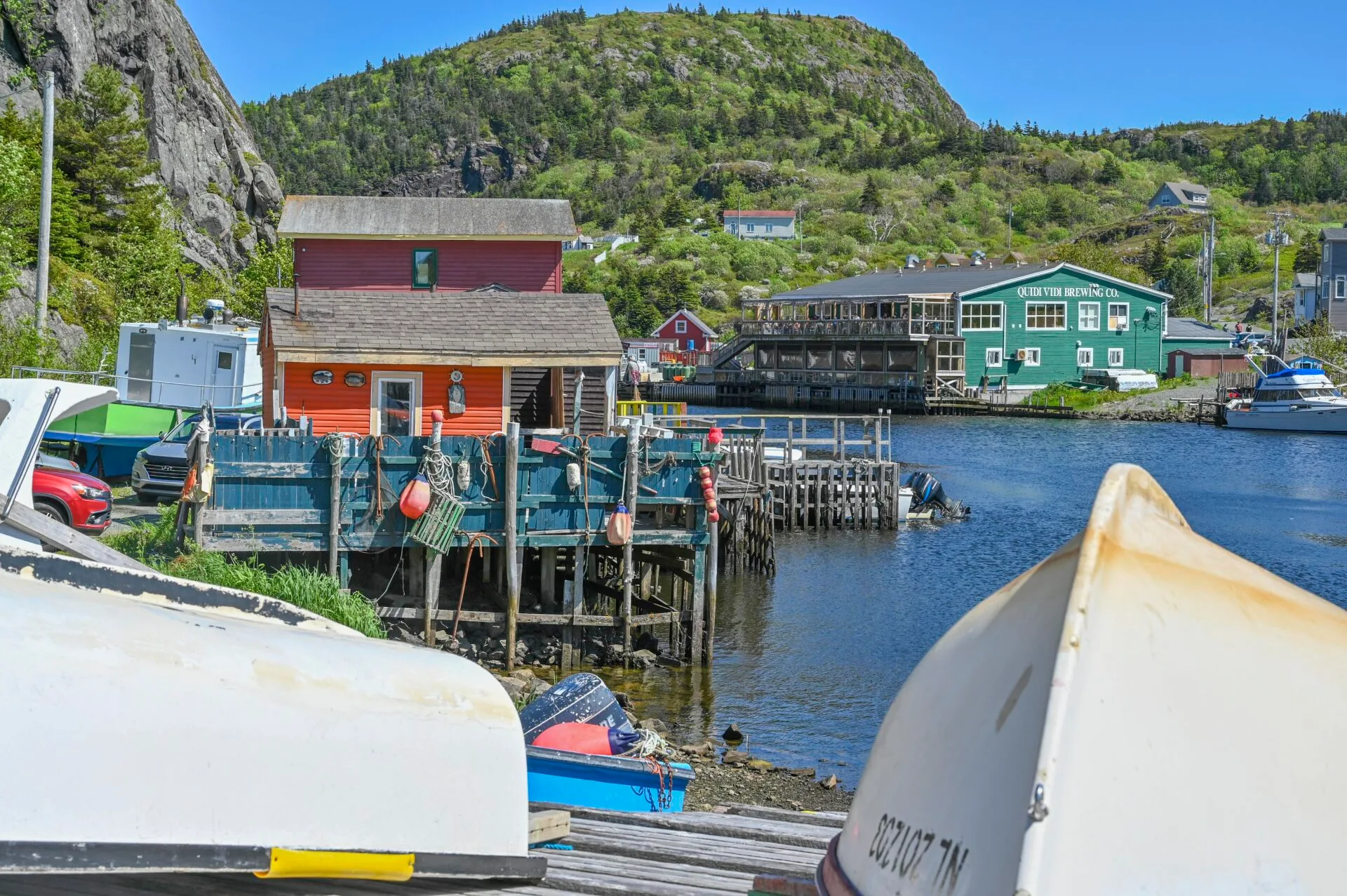 looking over the bottom of two boats at the fishing village and brewing restaurant in quidi vidi village