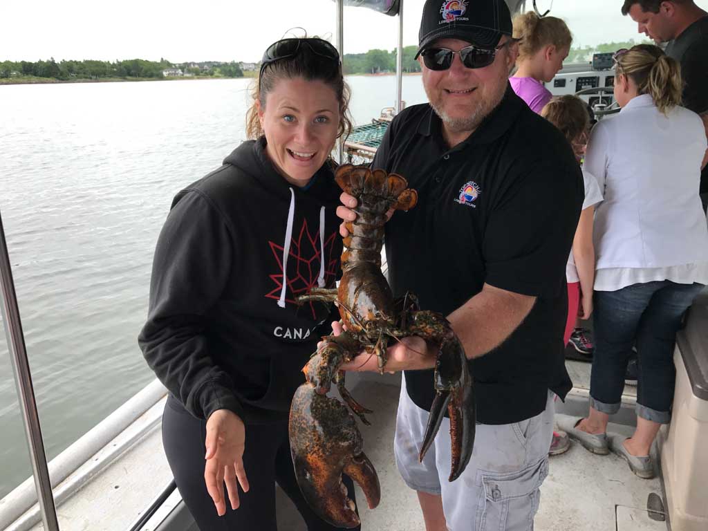 Jami Savage posing with nine pound lobster on the Top Notch Charters boat