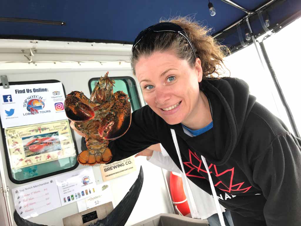 woman-holding-lobster-on-top-notch-tours-PEI