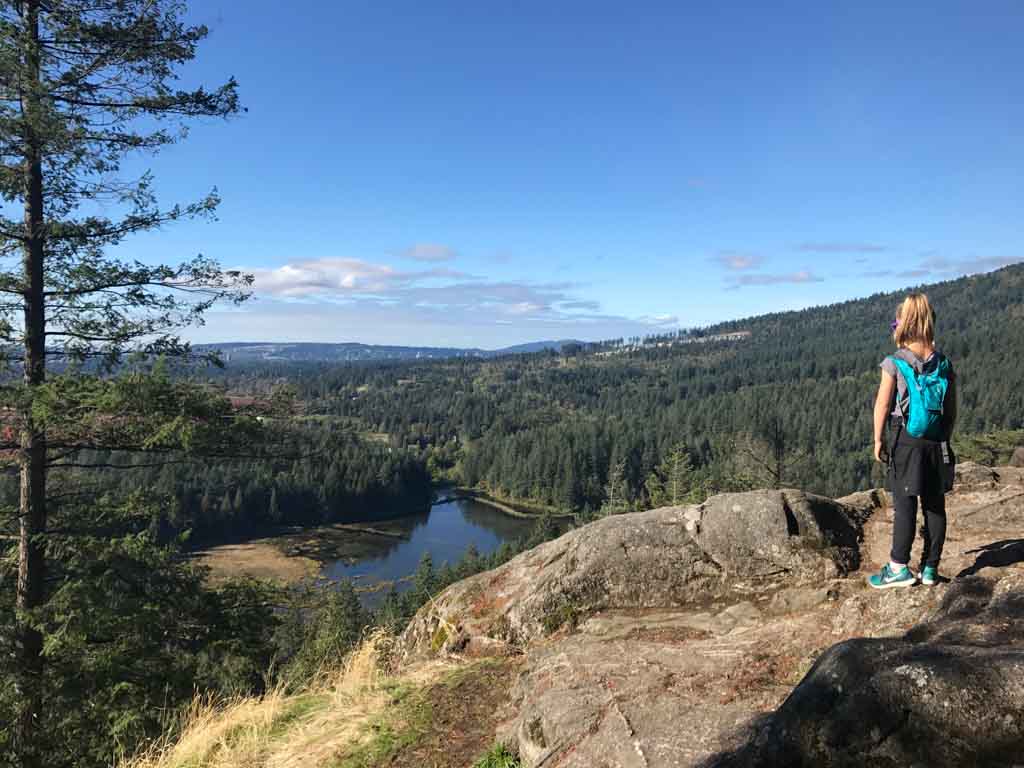girl standing at top of minnekhada park high knoll trail, a family friendly hikes fraser valley