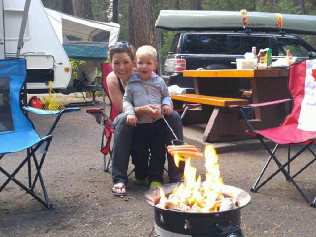 family-sitting-around-campfire