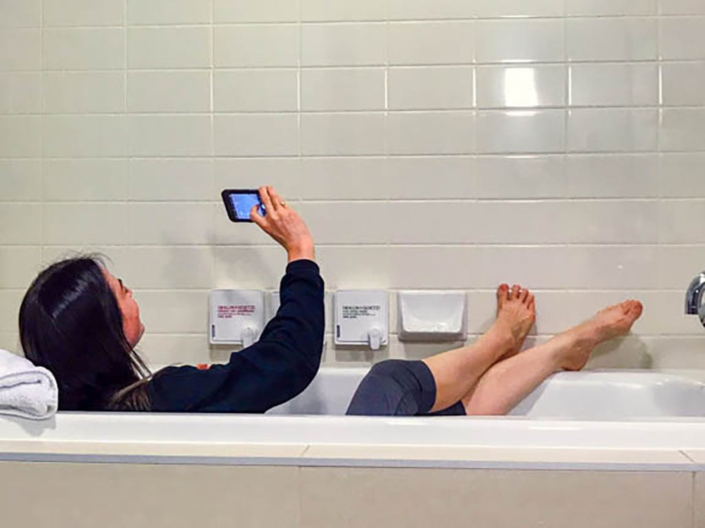 woman-taking-selfie-in-tub