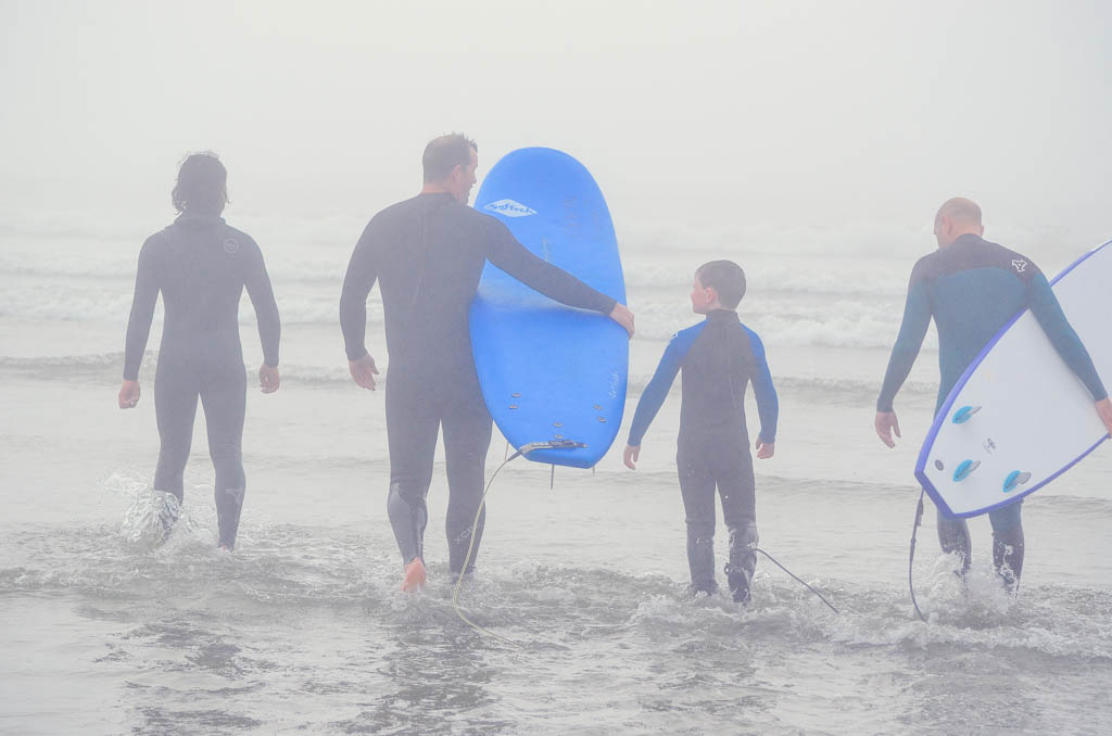 Family walking into the water during their Tofino Surf School review