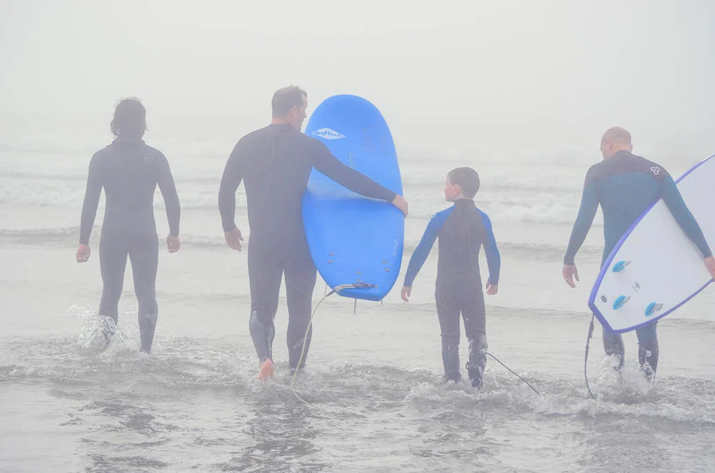 Family walking into the water during their Tofino Surf School review