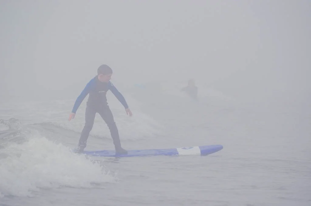 Boy surfing in Tofino