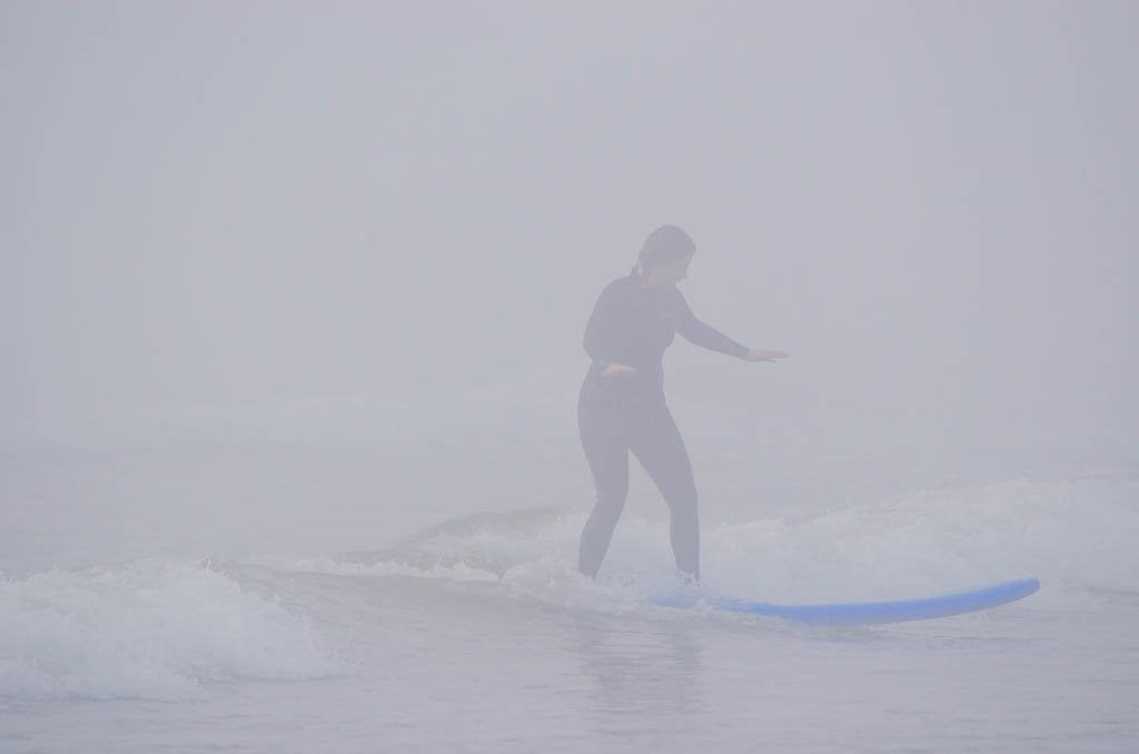 Jami Savage surfing during her Tofino Surf School review
