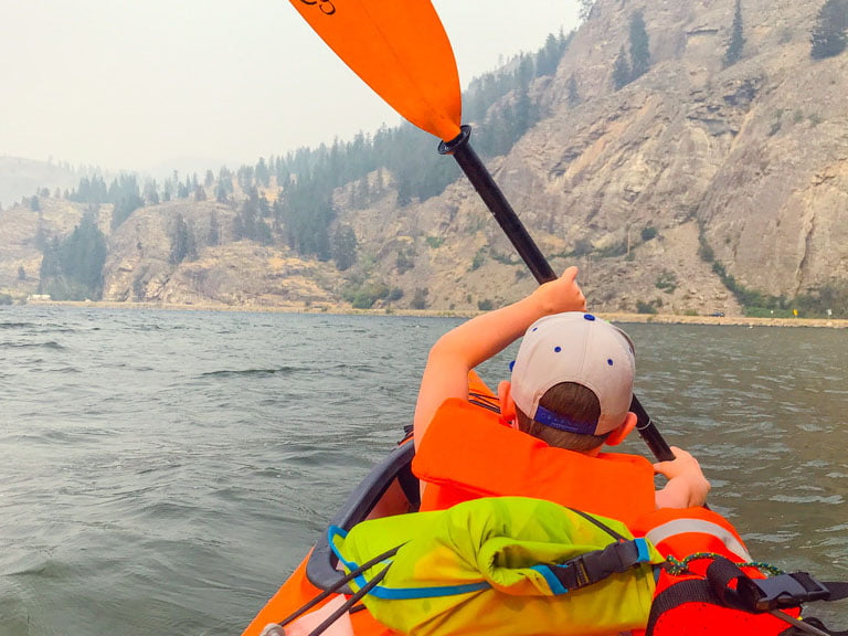 Boy paddling kayak at hoodoo adventures penticton 