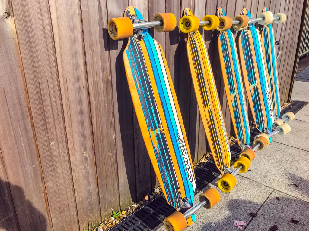 longboards-leaning-against-fence