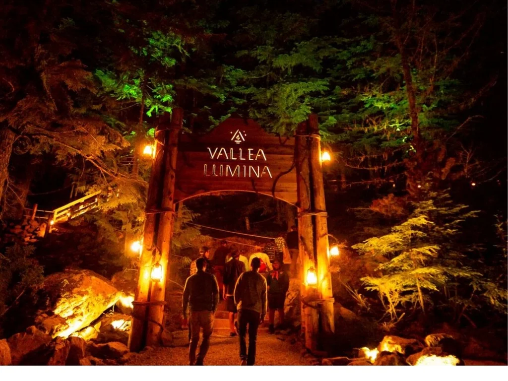 people walking under large vallea lumina review sign