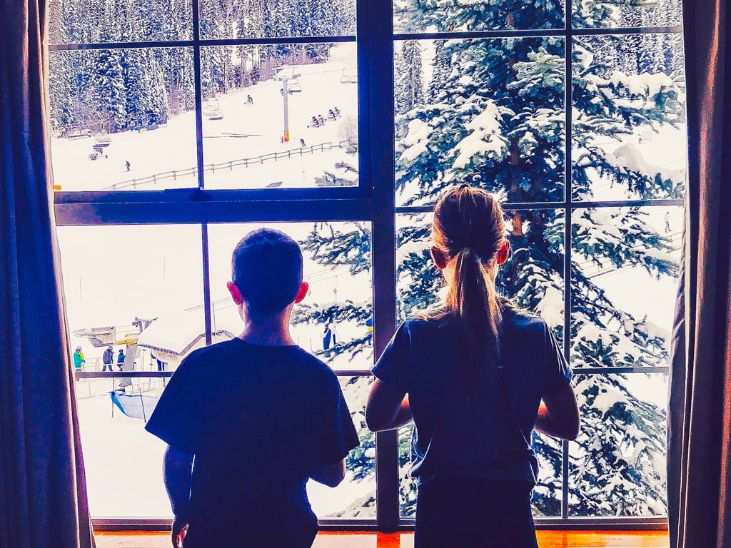 boy-and-girl-looking-out-sun-peak-hotel-window