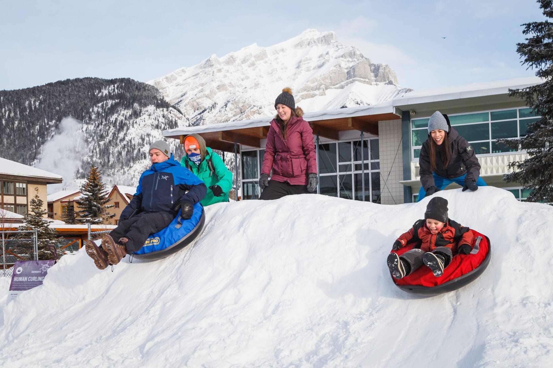 family participating in human curling at the banff snow days festival