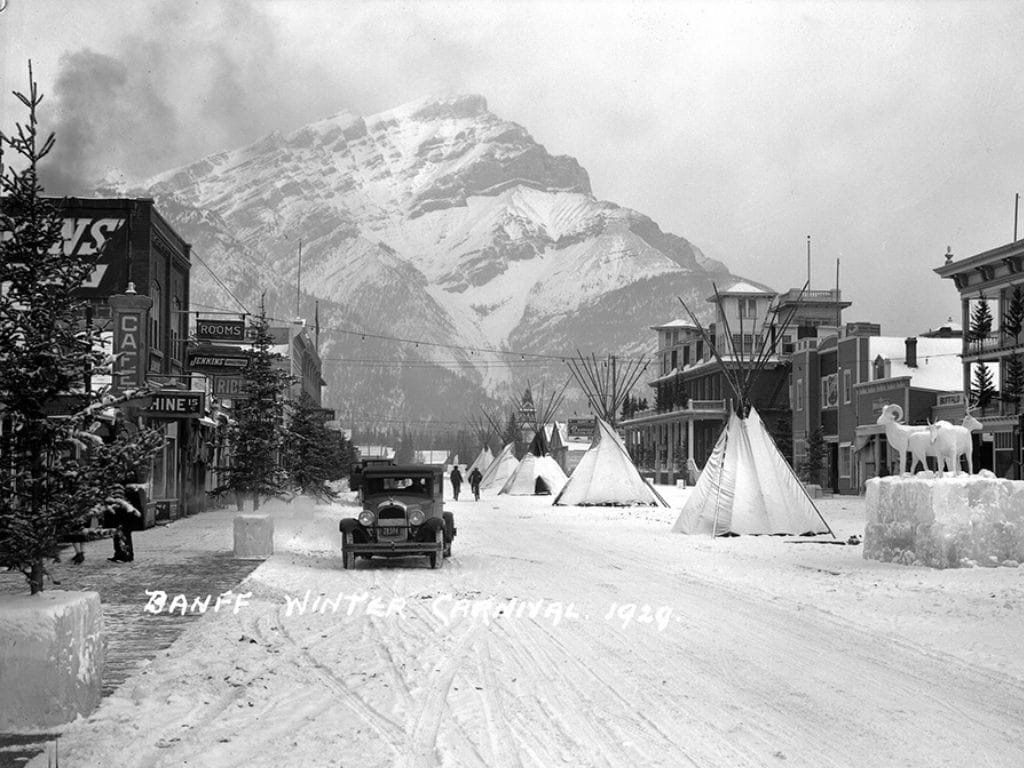 historic black and white photo of the downtown street in banff during the banff winter carnival in 1929