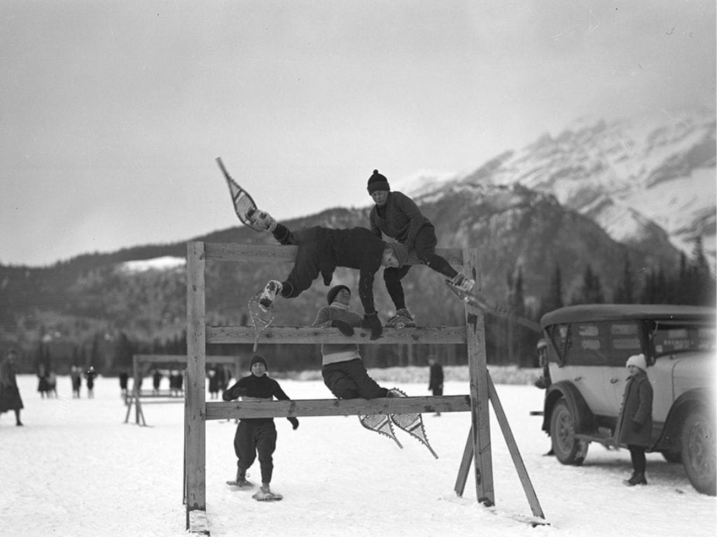 historic black and white photo of young kids taking part in a snowshoe obstacle race in 1930