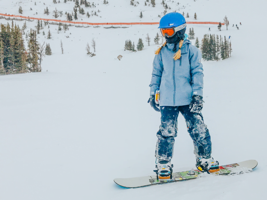 Girl snowboarding at Sunshine Village Ski & Snowboard Resort Banff