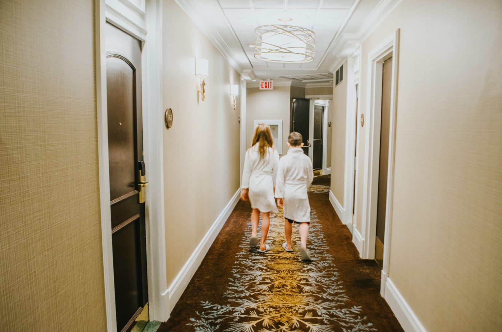 kids-walking-down-hallway-in-robes