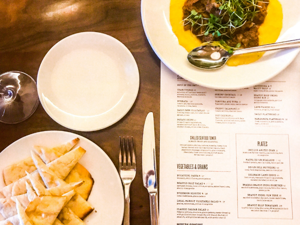 Food and menu on the table at marina kitchen restaurant