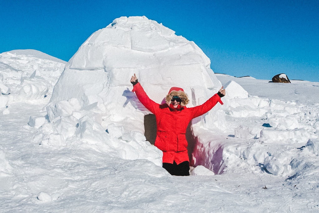 woman-in-igloo-while-snowmobiling-through-the-arctic