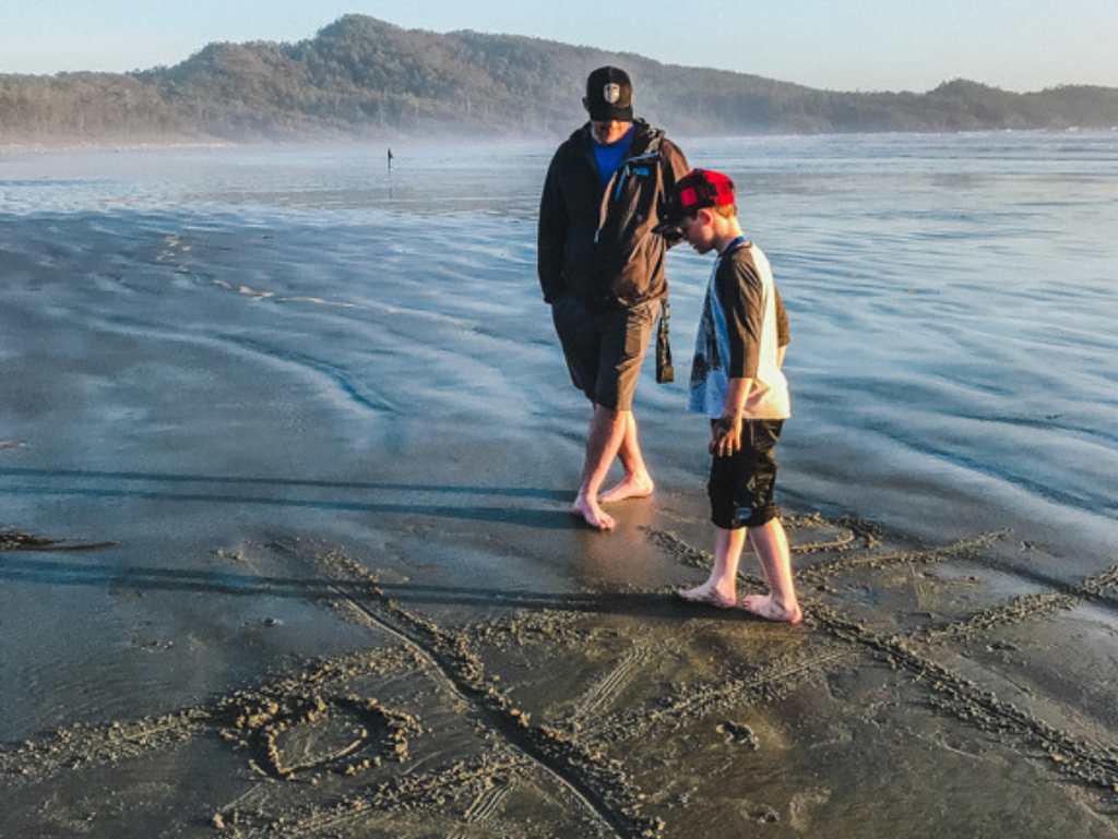 Father and Son playing on the beach at Long Beach Lodge, a Tofino family resort
