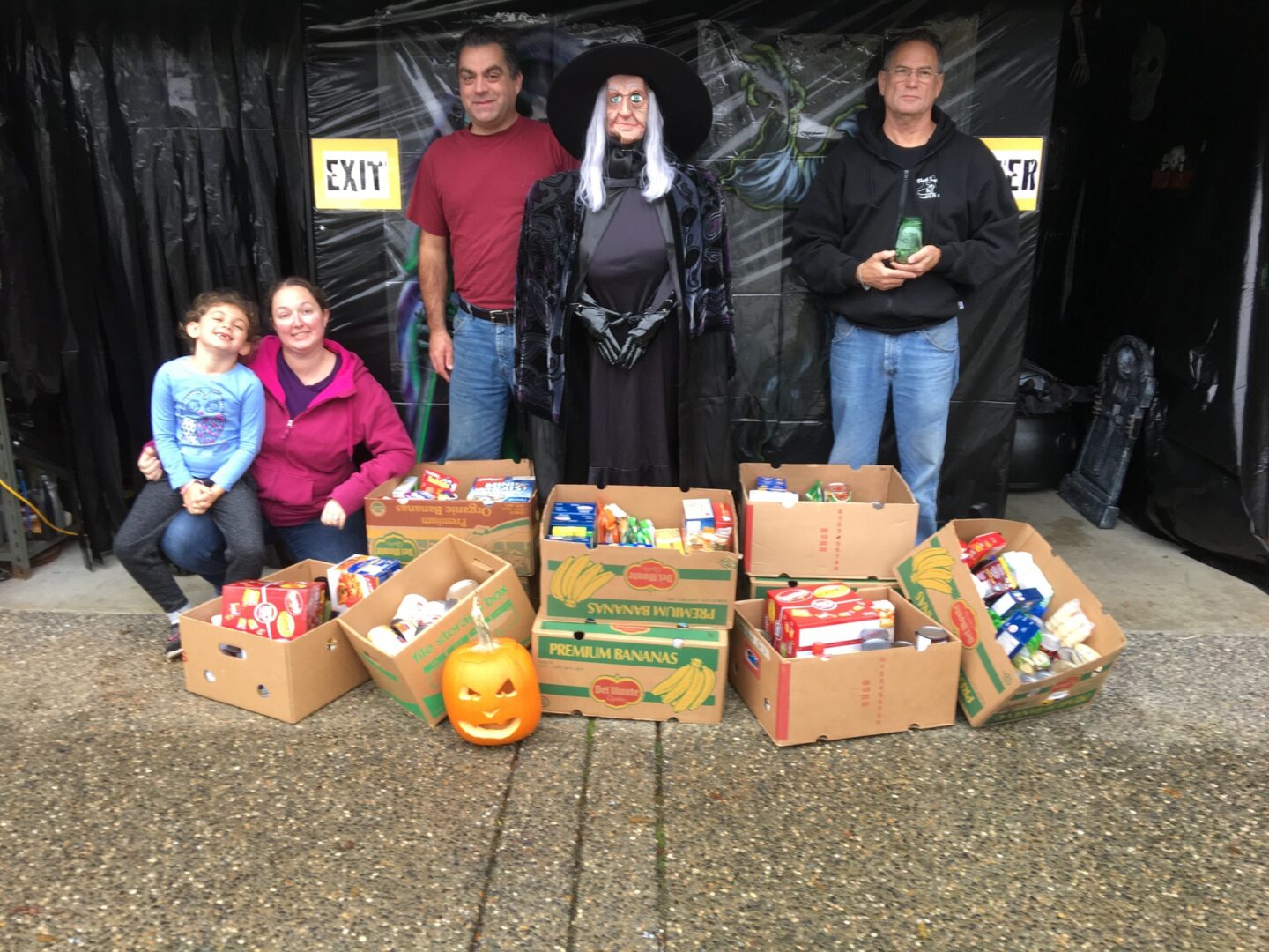 family standing outside haunted garage at haunted house langley with food bank donations