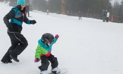 Jami Savage running after girl snowboarding