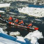 canoe races through frozen waters