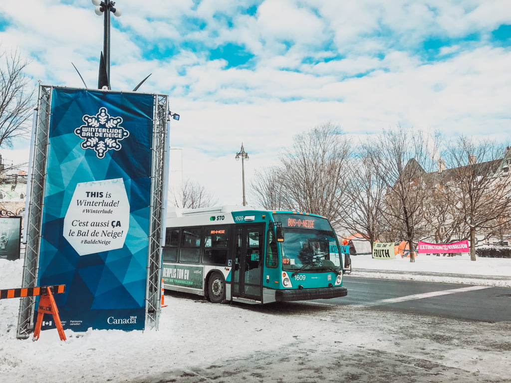 sno bus waiting to load passengers and take them to winterlude guide