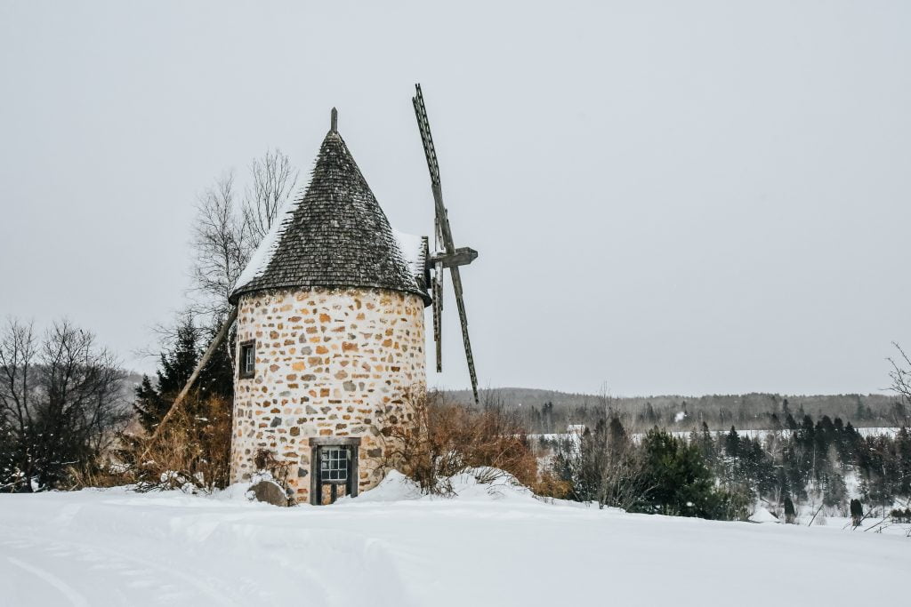 Old brick windmill in the snow at Le Baluchon Éco Villégiature