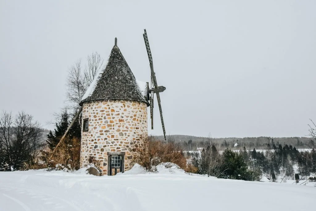 Old brick windmill in the snow at Le Baluchon Éco Villégiature