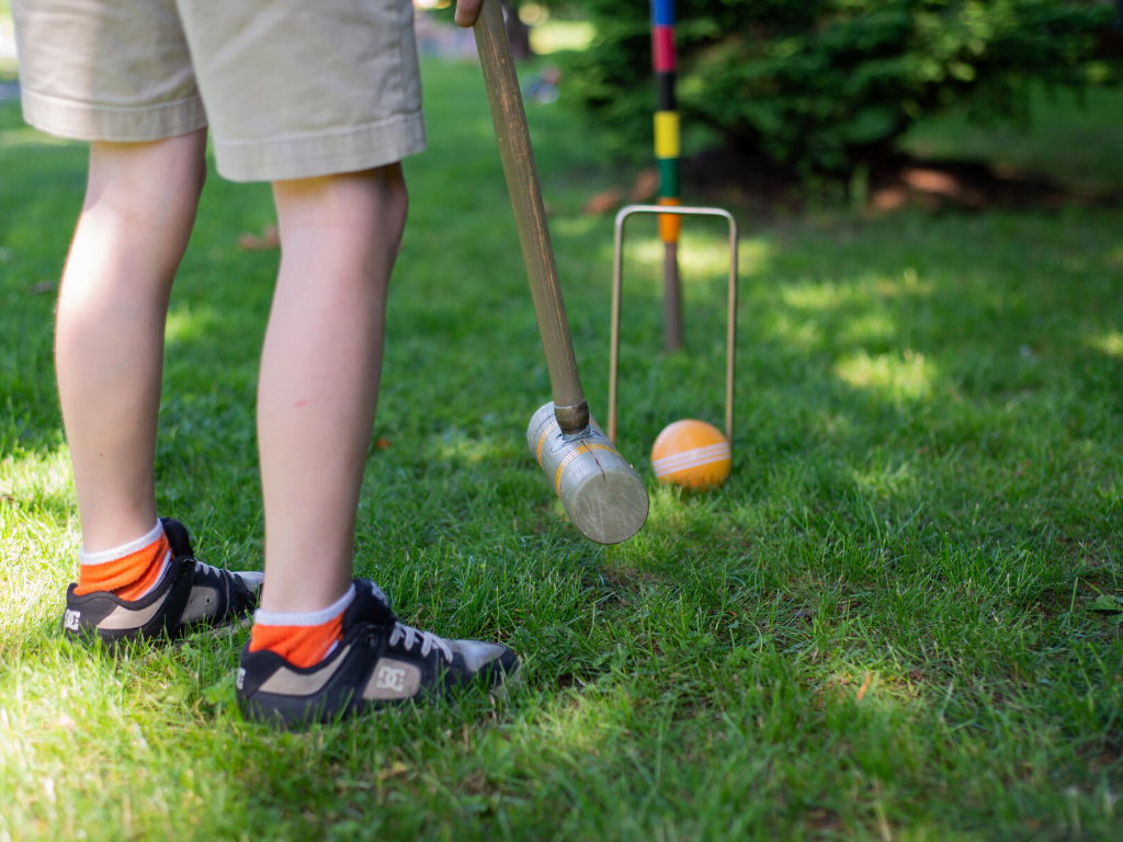 child playing croquet 
