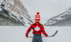 girl playing ice hockey on lake louise