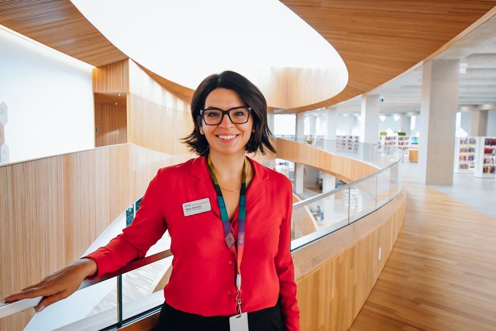 the director of communications at the calgary central library standing in the main hallway