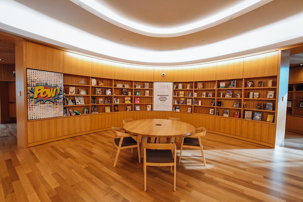 corner study space with a round table and bookshelves behind