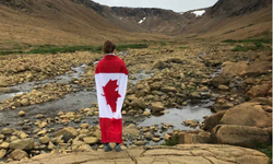 woman holding canada flag in gros morne national park