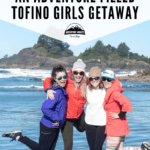 4 women smiling while standing on a beach in Tofino BC