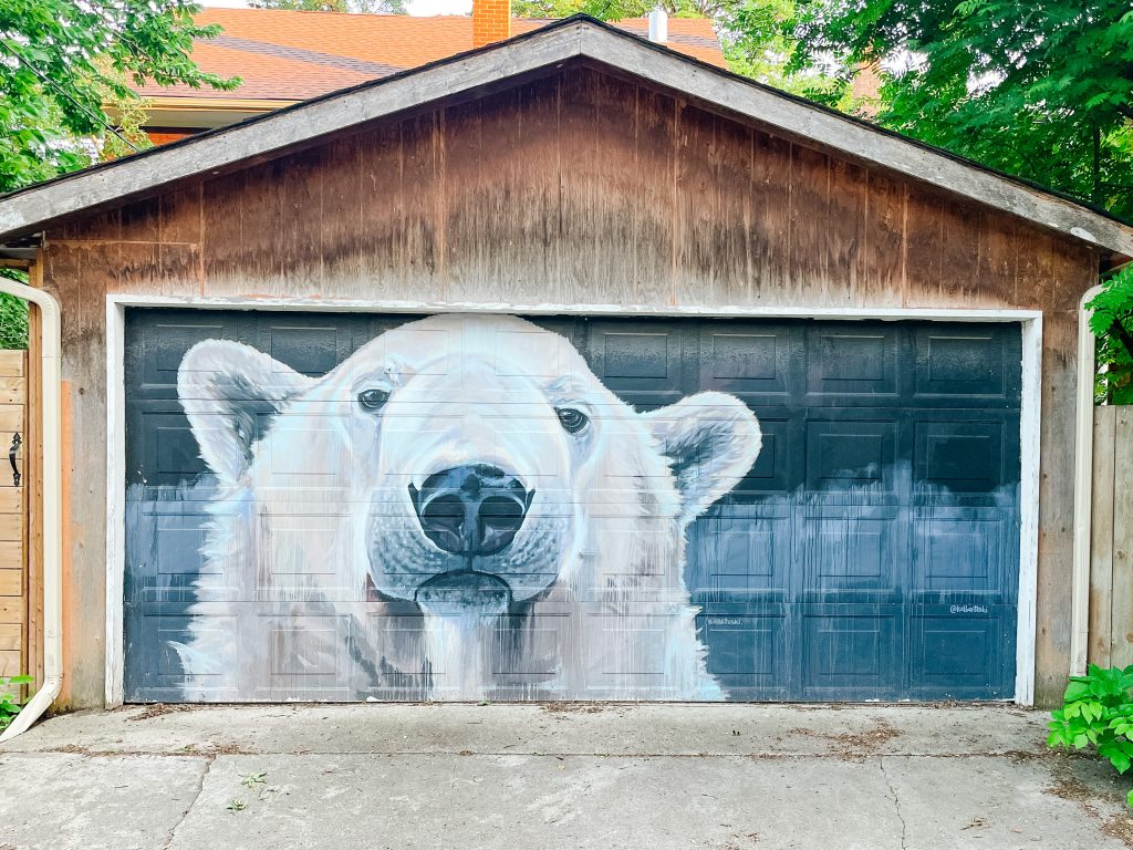 a mural of a polar bears head and face on a garage door