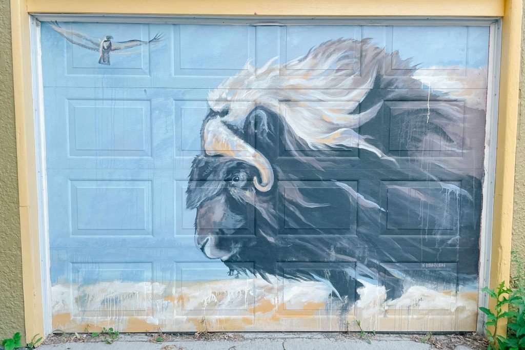 a mural of a bison running
