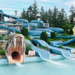 4 waterslides, one is the open mouth of a large snake