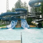 two large blue waterslides and one black hole waterslide
