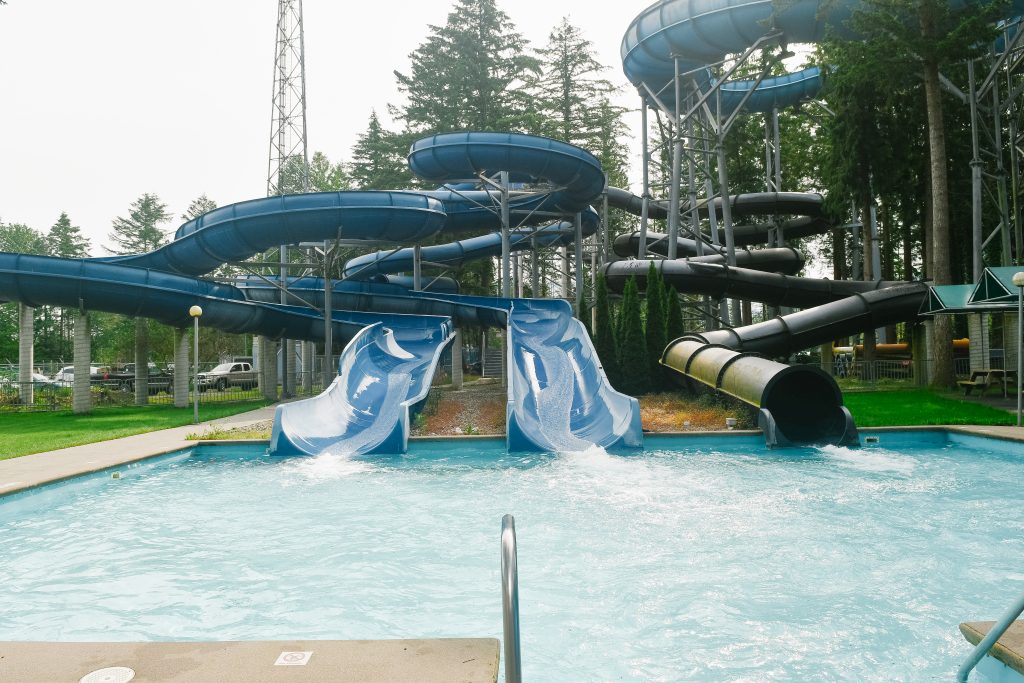 two large blue waterslides and one black hole waterslide