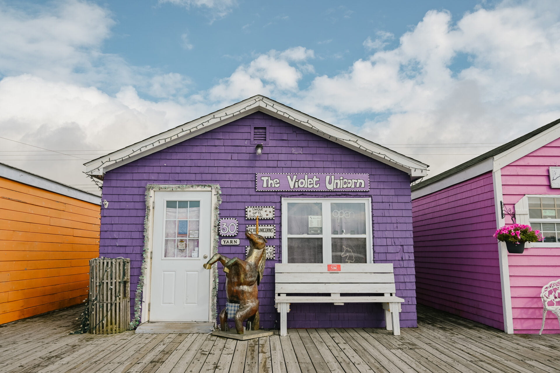 outside view of a small purple shop, the violet unicorn, in fisherman's cove nova scotia