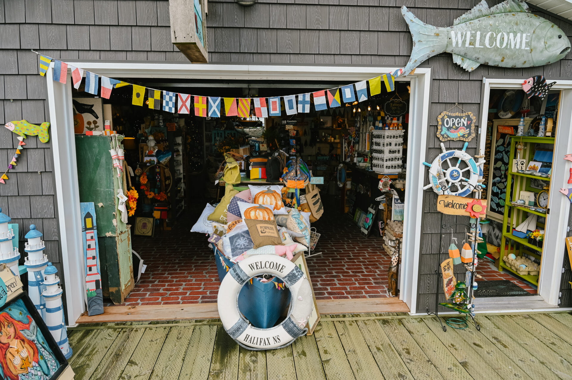 front entrance view of the She Shed store, the door is open and nautical themed items can be seen